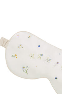 Close-up of Sweet Garden Silk Eye Mask floral embroidery highlighting delicate garden-inspired details.