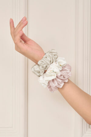 Wrist styled with the Sweet Garden Silk Hair Scrunchies Set-Three in Ballet Pink, Almond Beige, and Champagne Gray.