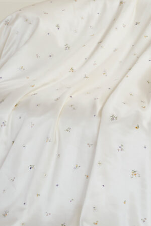 Sweet Garden Silk Throw featuring soft draping silk fabric with delicate floral motifs in a smooth, elegant finish.