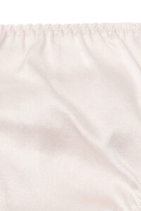 Detail of Tacetto silk brief in pink, showing the soft sheen and delicate fabric drape for a luxurious finish.