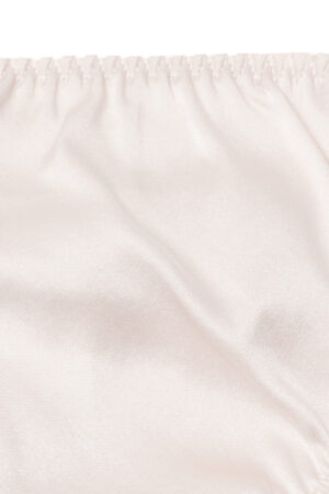 Detail of Tacetto silk brief in pink, showing the soft sheen and delicate fabric drape for a luxurious finish.