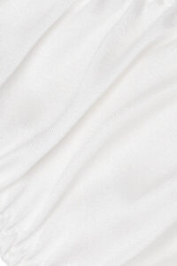 Close-up of Tacetto silk brief in white, highlighting the smooth, lustrous texture and refined stitching details.