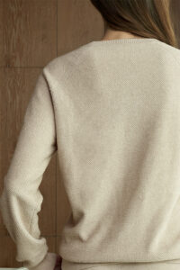 Back view of woman in beige Terra Knit Set, revealing the raised knit texture and soft natural drape.