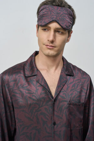 Model wearing Tropical Leaves Men's Eye Mask with relaxed expression, showing botanical motif and restful bedtime elegance.