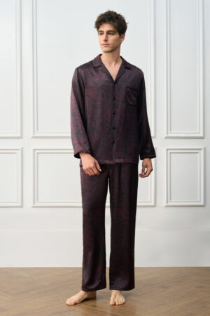 Model wearing Tropical Leaves Men's Pajama Set, full-length view of relaxed fit and delicate cocoa botanical print.