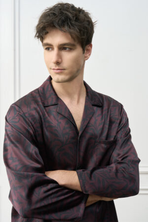 Model crossing arms in Tropical Leaves Men's Pajama Set, showcasing a tranquil loungewear mood.