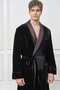 Model in the Tropical Leaves Velvet Men's Robe, featuring the matte black velvet finish and tropical-pattern contrast collar.