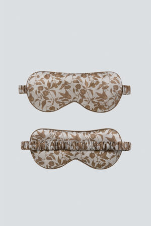 Overview of MANITO Tropical Silk Eye Mask in light taupe color, the top showing the floral design front and the bottom.