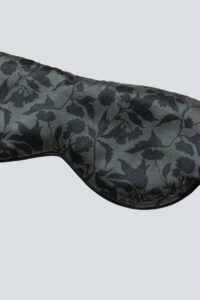 Close-up of the front of MANITO Tropical Silk Eye Mask in vetiver color, showing the floral pattern.