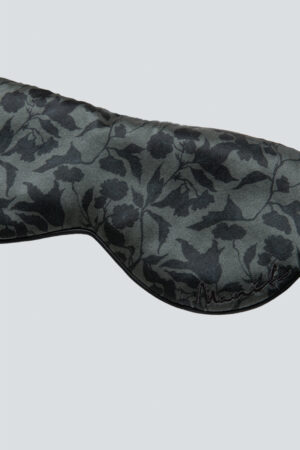 Close-up of the front of MANITO Tropical Silk Eye Mask in vetiver color, showing the floral pattern.