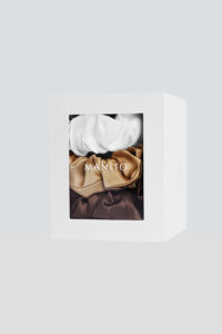 3 Pack Large Silk Scrunchie Set in white, gold, and brown presented in a gift box, blending luxury texture with refined simplicity.