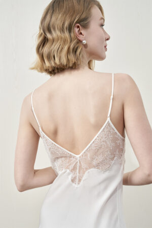 Close-up of back lace on MANITO Wedding Floral Lace Silk Mini Dress worn by model.