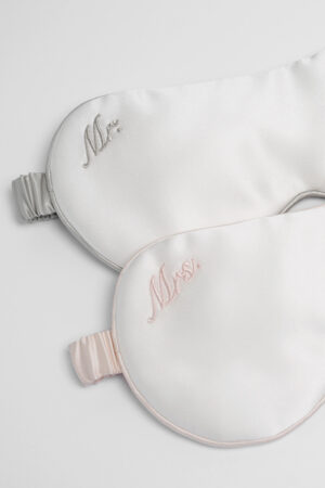 Close-up of “Mr” and “Mrs” embroidered MANITO silk eye masks from the Wedding Mr. & Mrs. Silk Eye Mask Gift Box.
