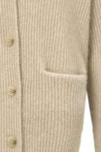 Detail of Wunder Cardigan pocket under soft light, revealing delicate knitting and cozy craftsmanship.