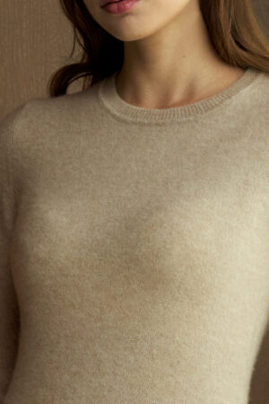 Close-up of the beige Wunder Knit Dress fabric showing its smooth, delicate knit texture.