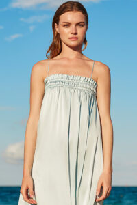 Elegant woman wearing Blooming Silk Midi Slip Dress in a chic summer style.