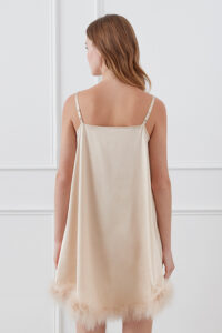 Back view of Diva Feather Women's Trimmed Short Slip Dress in champagne highlighting the flowing silhouette and feather trim.