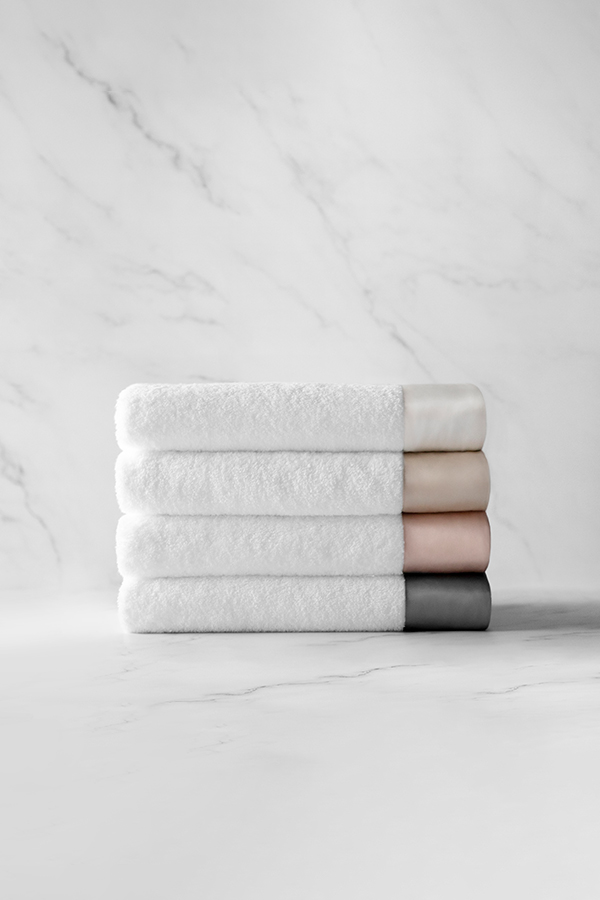 MANITO Brimmy 3 Piece Bath Towel Set in four colors, pure cotton towels with 100% mulberry silk trim stacked neatly.