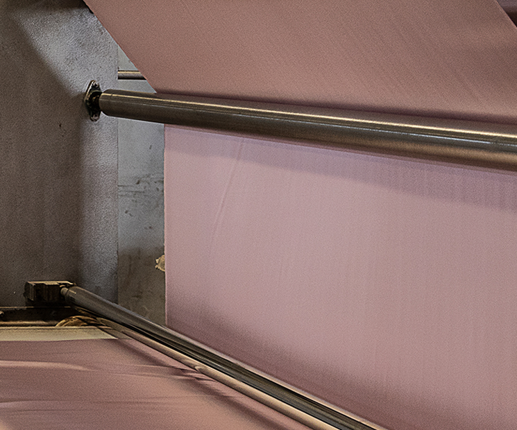 MANITO's elegant pre-finishing process of silk fabric, akin to a natural canvas, where the serene beauty of silk comes to life in a heated environment, shedding its sericin to reveal a world of lustrous enchantment.