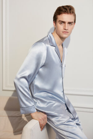 Man poses confidently in an Authentic Silver Silk Pajama Set, showcasing a sleek and modern nightwear choice.