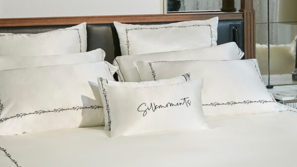 Luxurious bedroom with silk pillowcases highlighting the benefits of silk pillowcase for skin and hair health.