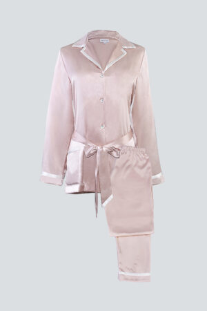 Flat lay of blush pink Coco Lady Pajama Set with ivory piping and soft silk sheen.