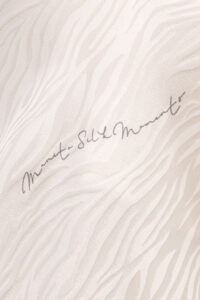 Fabric close-up of MANITO Jungle Tiger Print Short Pajama Set highlighting tiger-inspired jacquard silk design.