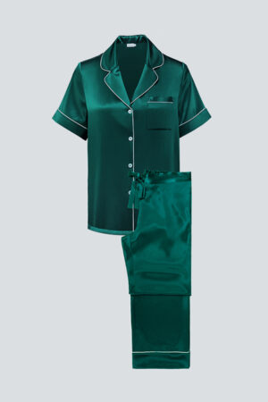 Flat lay of emerald green MANITO Authentic Short Sleeve Pajama Set with white piping and luxurious finish.