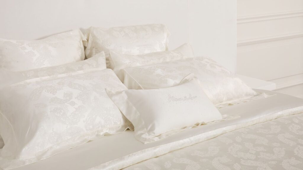 Elegant cream silk bedding set with ornate patterns showcasing hypoallergenic silk benefits.