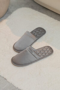 Authentic Men's Silk Lounge Shoes in grey, showing satin-silk finish with lamb-leather trim and the diamond-quilted insole detail.