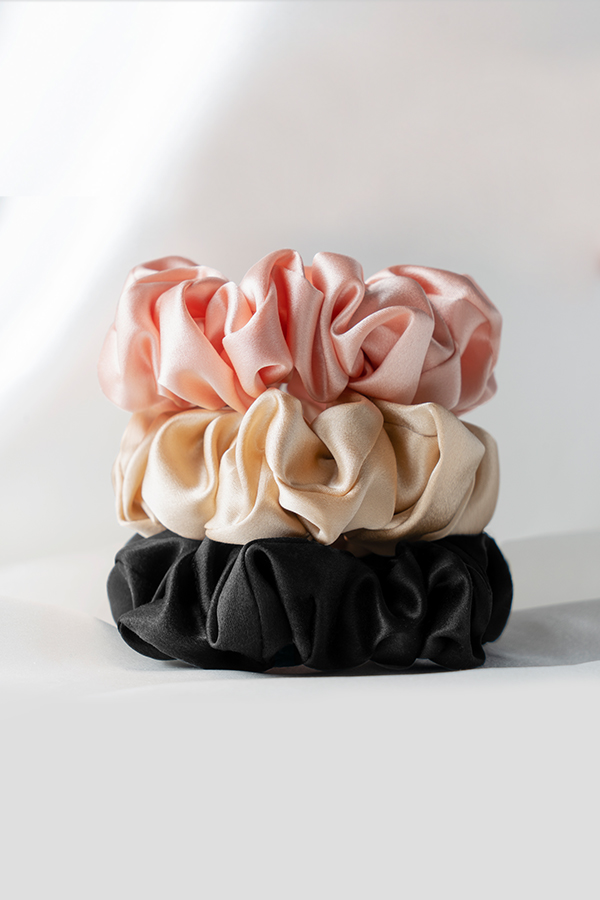 3 Pack Large Silk Scrunchie Set featuring pink, champagne, and black, crafted from soft silk for effortless elegance.