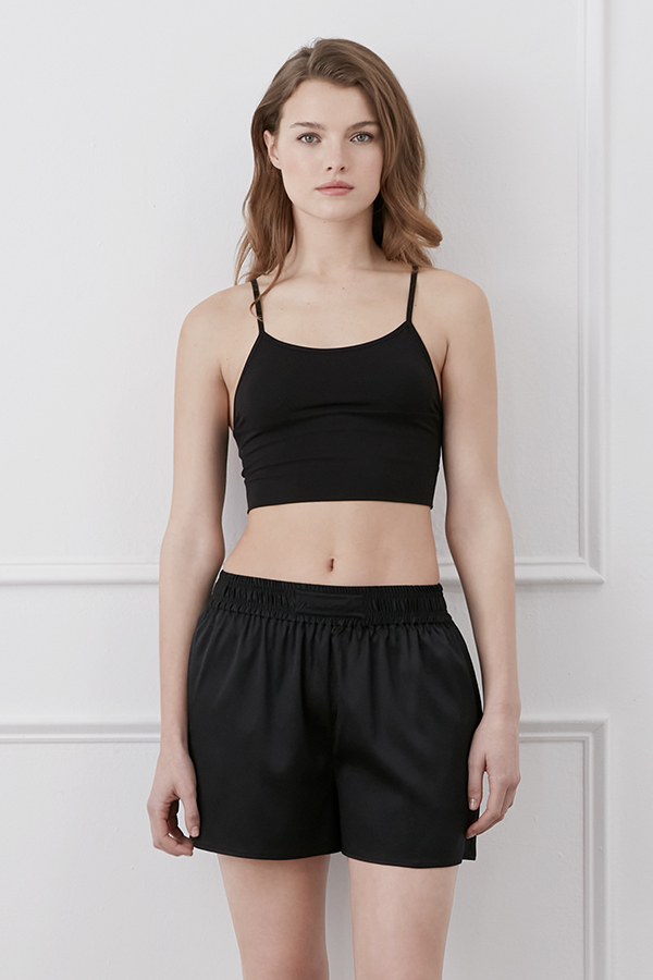 Passion Women's Silk Shorts in black styled with crop top, featuring a relaxed fit.