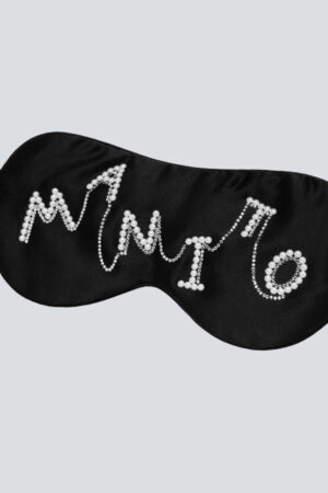Close-up of Pearlwear Silk Eye Mask in black, featuring crystal-and-pearl MANITO lettering for a luxurious touch.