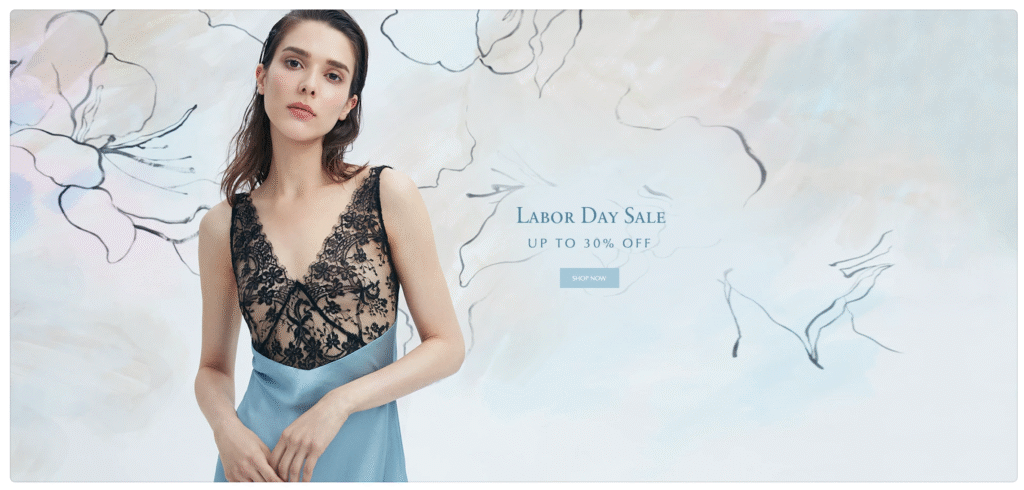 A woman in a light blue silk camisole with black lace details.