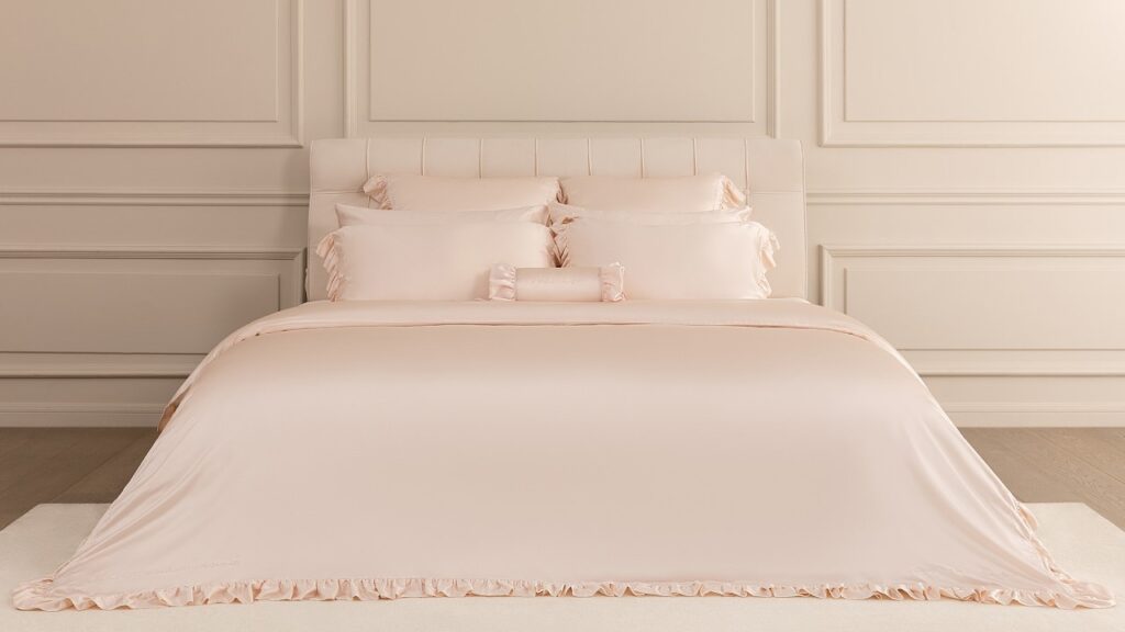 Elegant silk bedding set on a luxurious bed, showcasing how to care for and dry silk pillowcases.