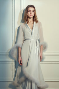 Woman in MANITO Diva Feather Trimmed Long Robe with hand-stitched feather trim.