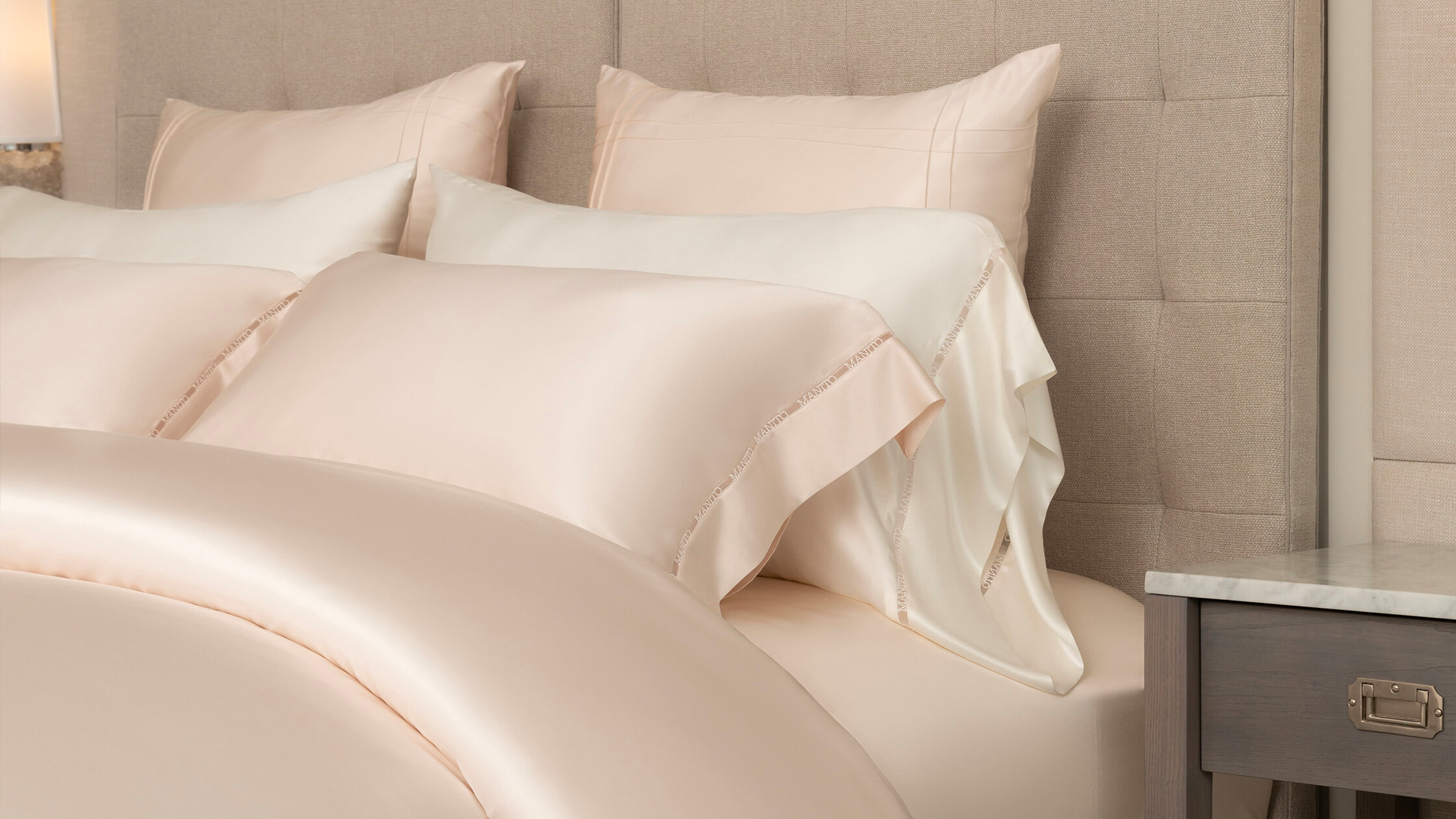 Close-up of luxurious beige silk bedding, safe and smooth for infants' delicate skin.