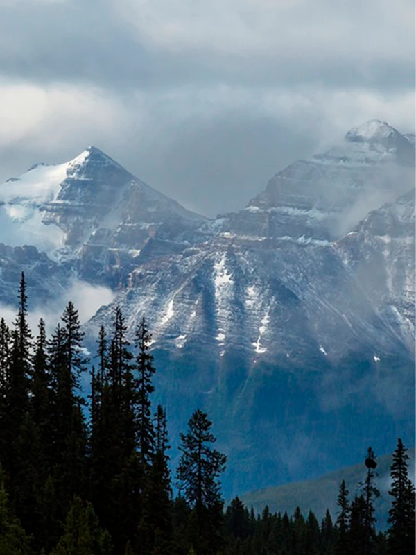 Snow-capped mountains shrouded in mist, embodying the natural purity MANITO resonates with.