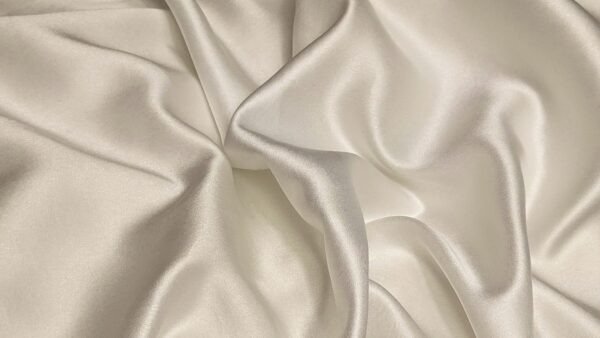 Smooth and lustrous fabric texture of high-quality mulberry silk, showcasing the material's natural sheen.
