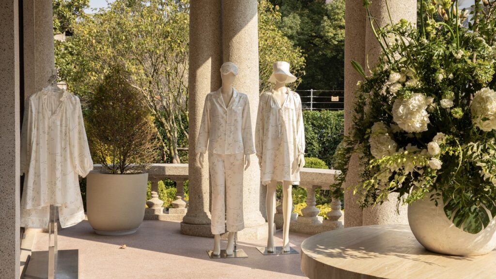 Elegant white floral-patterned pajamas and robes on mannequins for a soothing self-care routine.