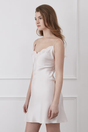 Side view of ivory Latica Lace-trimmed Slip Dress with French lace V-neckline and flowing silk drape.
