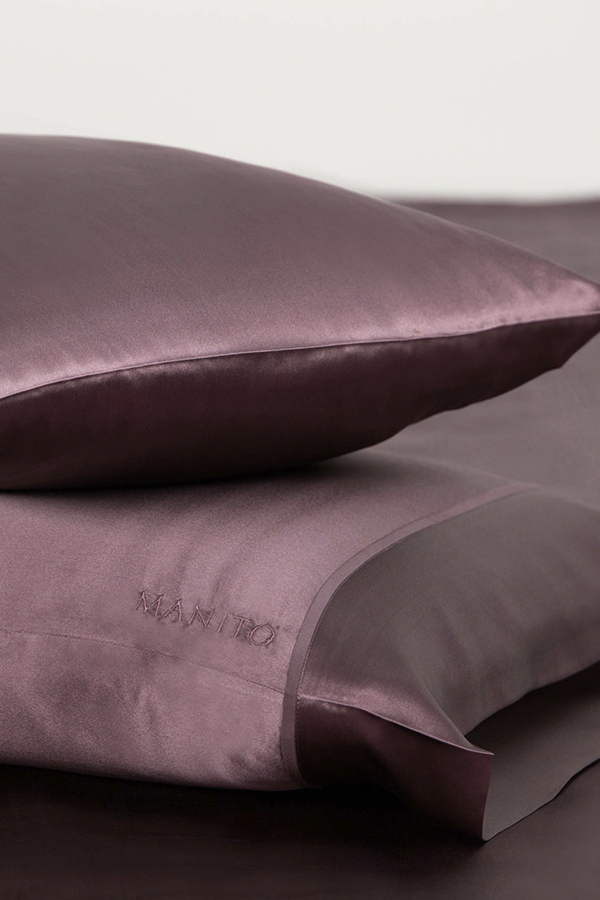 Plum purple silk pillowcase set with signature MANITO embroidery for a touch of elegance.