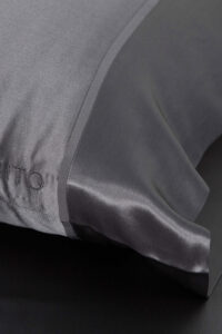 The 22 silk pillowcase set in a sleek charcoal shade, combining luxury with modern design