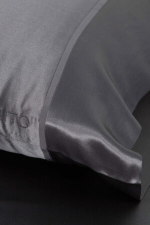 The 22 silk pillowcase set in a sleek charcoal shade, combining luxury with modern design