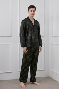 Smiling man wearing Signature MT Men's Pajama Set shows the comfort and luxury of the clothes.