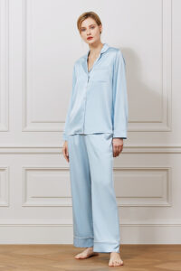 Model in light blue MANITO Treasure Silk Pajama Set highlighting smooth silk sheen and classic cut.
