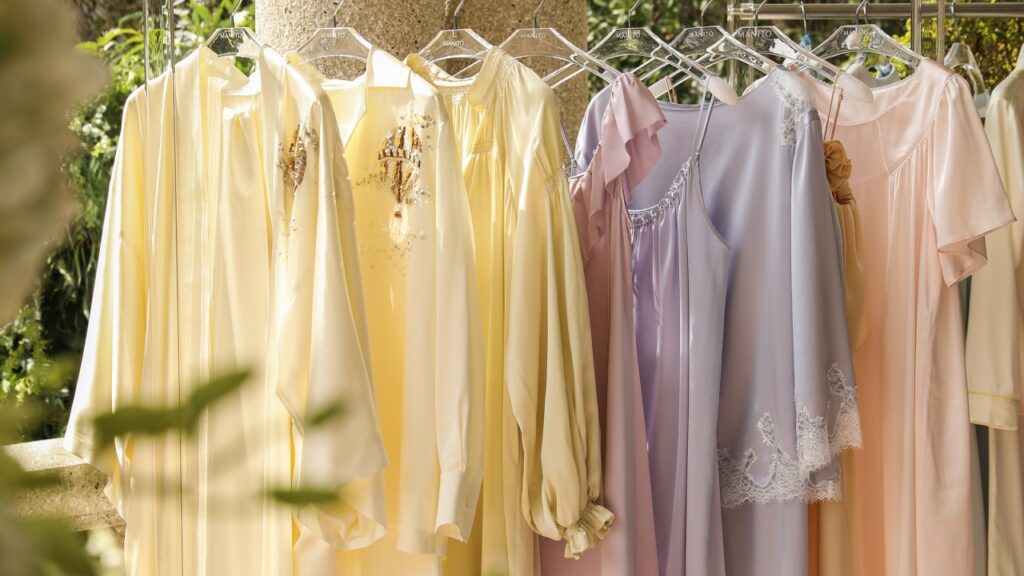 A serene display of silk robes in soft pastel colors for National Self-Care Day relaxation.