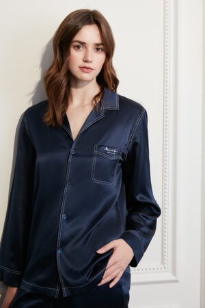 Woman in Liberty Silk Pajama Set featuring pastel hues with a classic design, exuding comfort and style.