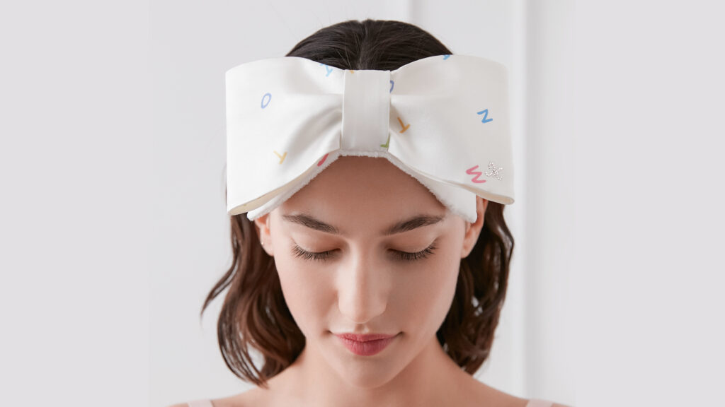  woman wearing a large silk bow headband