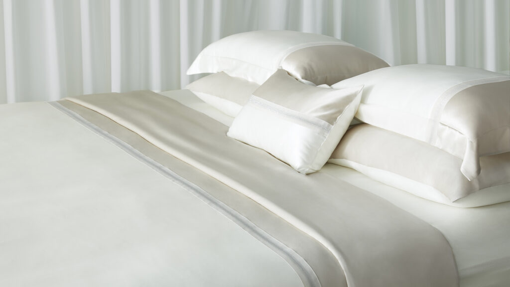 Smooth and silky fitted sheets on a neatly made bed